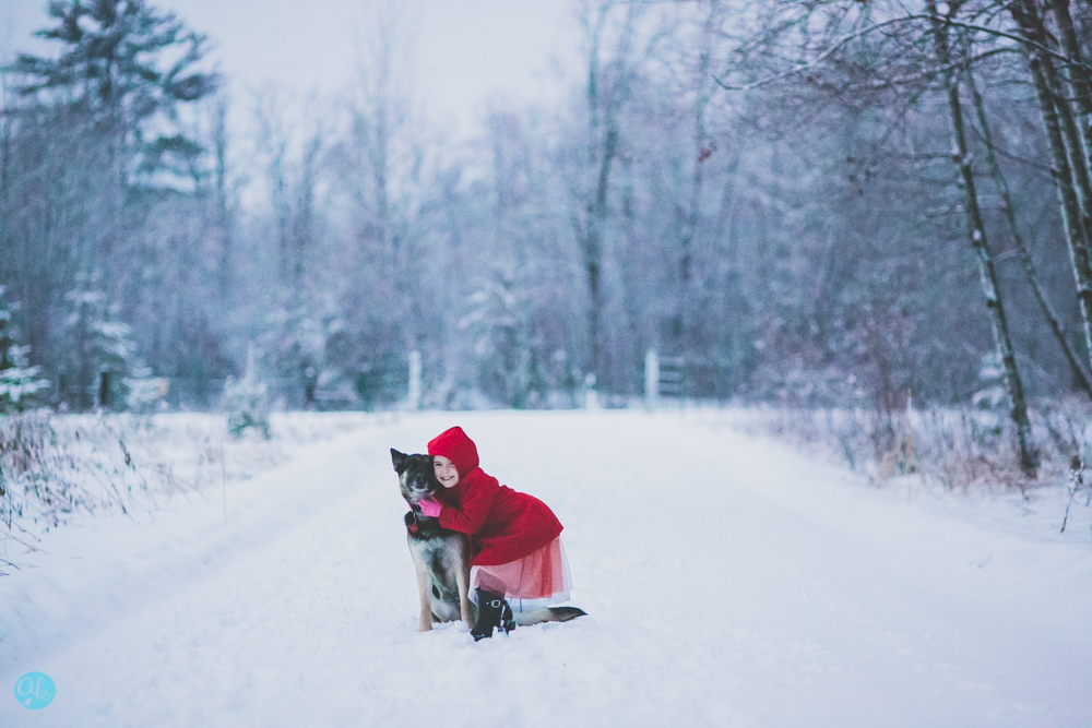 This Detailed Life Photographer Submission of little red riding hood in winter getting the mail. Black Boots, Red Jacket, Red Hood, Mailbox, Wintry Scene, Minnesota with German Shepherd. Cass Lake Minnesota Photographer Copyright 2021 Amy Kastenbauer, dba Amy Kate Photography