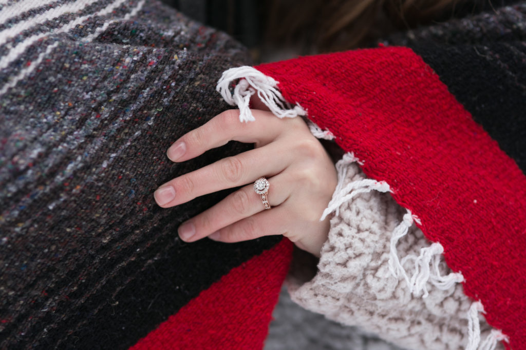  Gorgeous Engagement Ring Setting on Rose-Gold. Bride wearing Sherpa Fleece and a Red Blanket Wrap, Over Jeans for Snowy Engagement Session at State Park. 